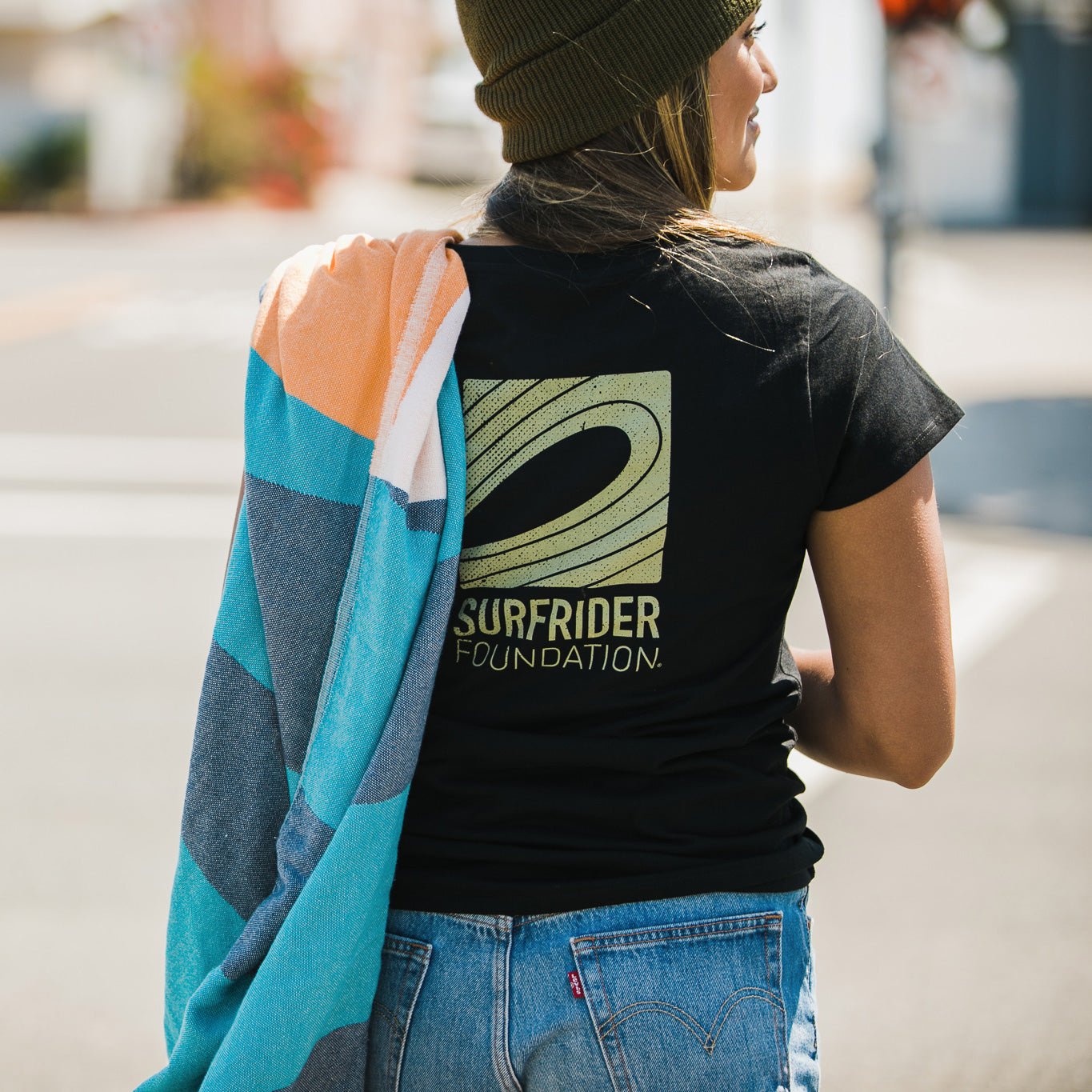 Back detail of graphic tee on model.