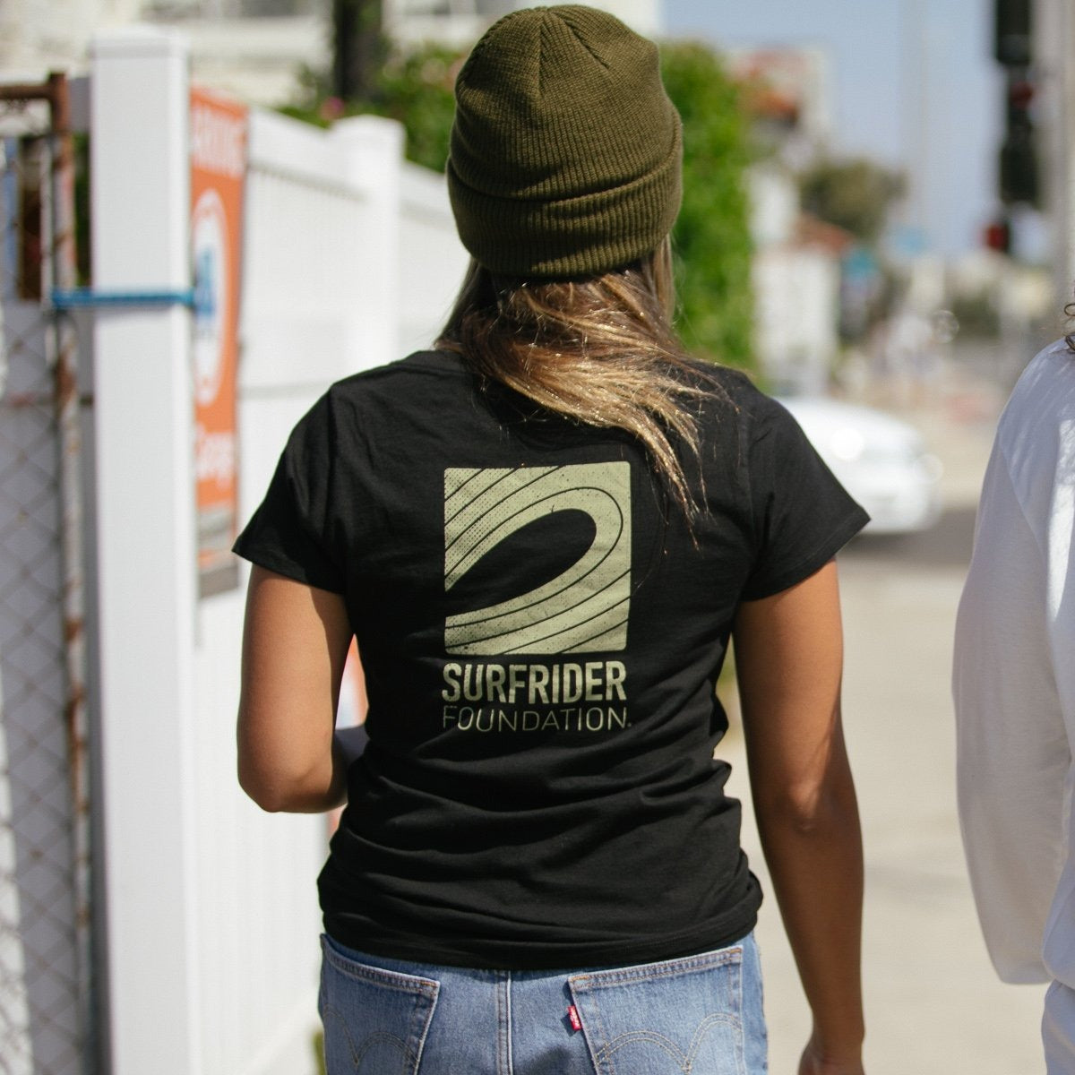 Back of tee on model shows off the Surfrider logo. 