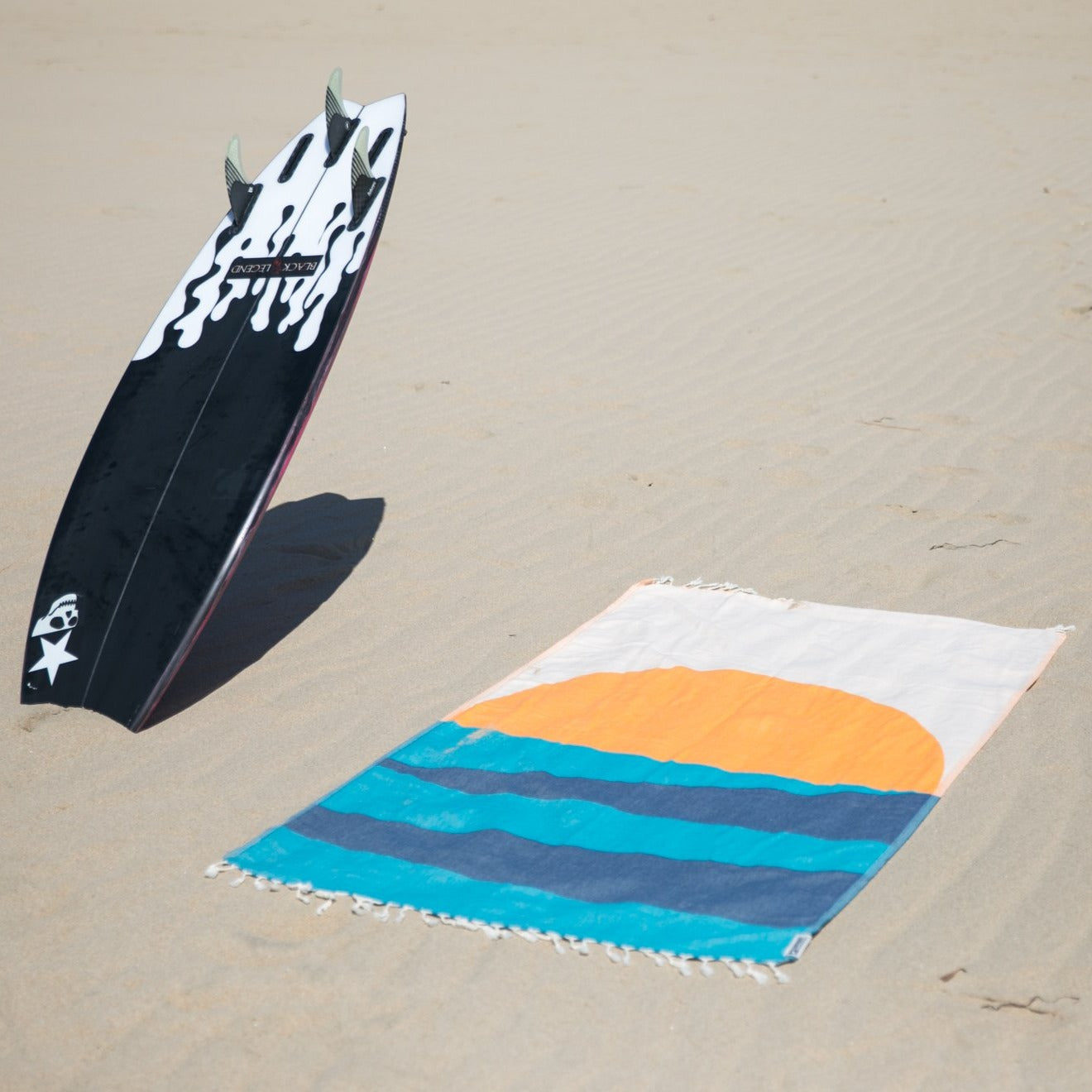 Beach towel with surfboard. 